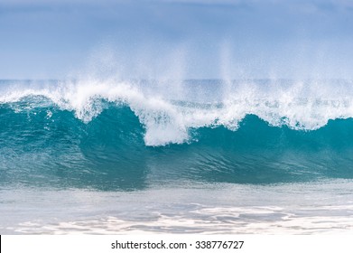 Powerful Wave Breaks Along The Shore
