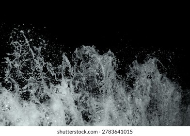 A powerful wave crashes dramatically against a dark background