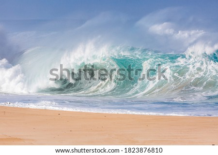 powerful wave exploding on a beach in hawaii