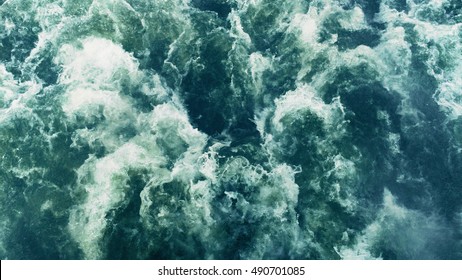 Powerful waves pulled out from fast moving boat, a huge stream of deep blue water with white foam rising up, steady beautiful shot, perfect for film, digital composition, Video Projection Mapping