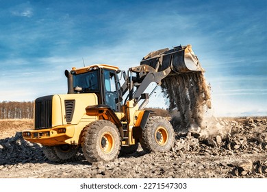 Powerful wheel loader or bulldozer working on a quarry or construction site. Earthworks in construction. Powerful modern equipment for earthworks - Shutterstock ID 2271547303