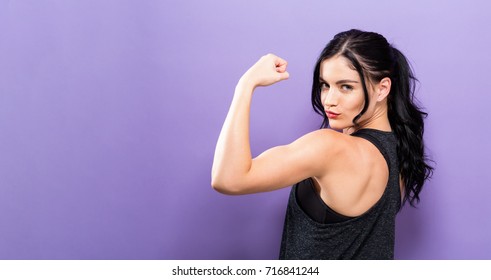 Powerful Young Fit Woman On A Solid Background