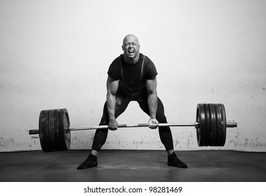 Powerlifter With Strong Arms Lifting Weights