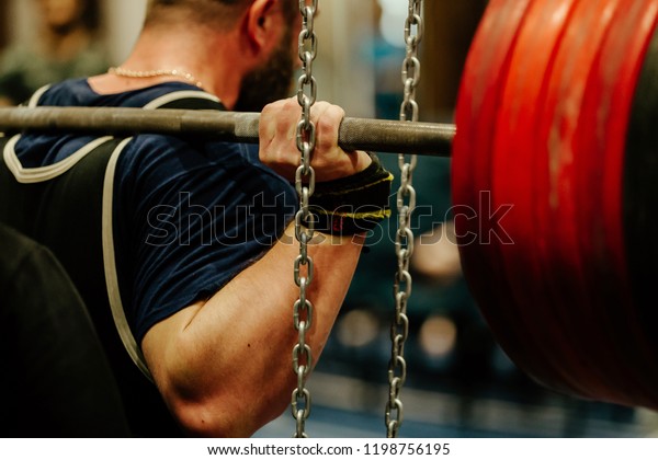 powerlifting back\
male athlete squat with\
barbell