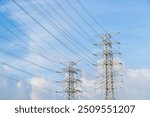 Powerline cables over the blue sky