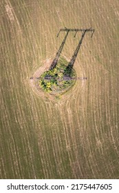 Powerline transmission tower alone on the mowed field