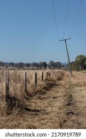 Powerlines And A Fence In The Outback, Queensland Australia