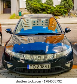 POZ, POLAND - May 22, 2021: Parked New Honda Car On A Parking Spot  Vehicle Has Reflection Of A Apartment Building 