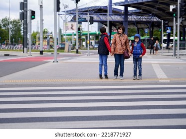 POZNA, POLAND - May 22, 2022: A Woman With Her Kids Waiting By A Zebra Crossing On The Rataje Roundabout, Poznan, Poland