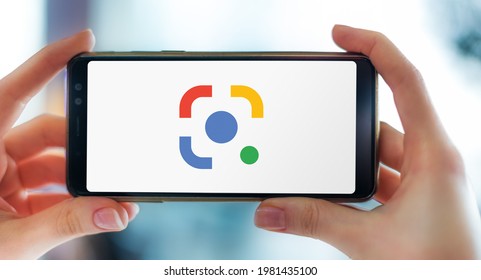 POZNAN, POL - APR 25, 2021: Hands holding smartphone displaying logo of Google Lens, an image recognition technology developed by Google