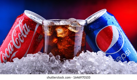 POZNAN, POL - FEB 13, 2020: Two Cans Of World's Most Popular Soft Drinks: Coca Cola And Pepsi And The Glass Of Drink With Crushed Ice