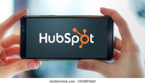 POZNAN, POL - FEB 6, 2021: Hands holding smartphone displaying logo of HubSpot, an American developer and marketer of software products for inbound marketing, sales, and customer service
