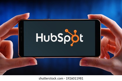 POZNAN, POL - FEB 6, 2021: Hands holding smartphone displaying logo of HubSpot, an American developer and marketer of software products for inbound marketing, sales, and customer service