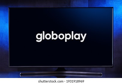 POZNAN, POL - FEB 6, 2021: Flat-screen TV set displaying logo of Globoplay, a Brazilian subscription video on demand service owned by Grupo Globo