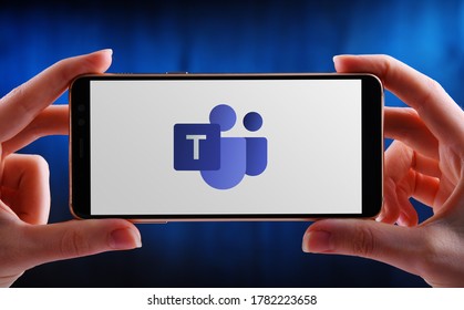 POZNAN, POL - MAY 21, 2020: Hands Holding Smartphone Displaying Logo Of Microsoft Teams, A Unified Communication And Collaboration Platform