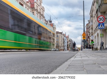 Poznan, Poland - 10.20.2021: tram blurred by motion. Architecture of the city in background. (Wilda district).