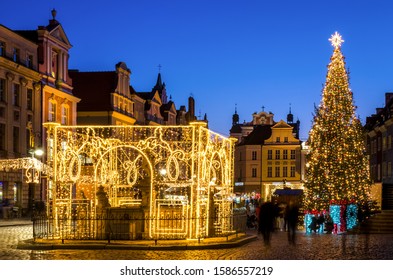 POZNAN / POLAND - 2019: A Christmas tree glittering with colorful lights and a Christmas market on the Town Hall Square