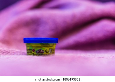 POZNAN, POLAND - Aug 30, 2020: Play Doh Blue  Clay In A Yellow Container In Soft Focus Background.