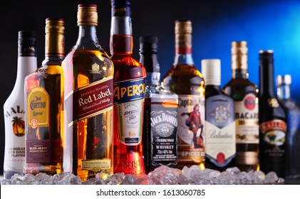 POZNAN, POLAND - DEC 20, 2019: Bottles of assorted global liquor brands including whiskey, vodka, gin and liqueur