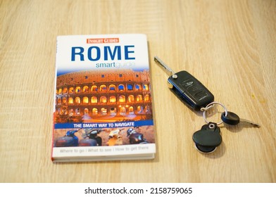 POZNAN, POLAND - Feb 20, 2022: A  Travel Guide About Rome Next To Car Keys On A Table 