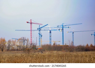 POZNAN, POLAND - Feb 23, 2015: A beautiful view of a group of high construction cranes on the Malta district, Poznan, Poland