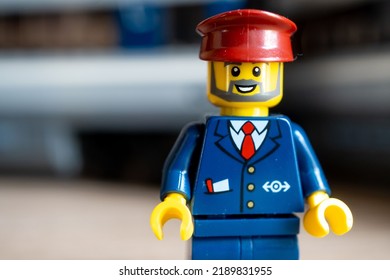 POZNAN, POLAND - Jul 03, 2022: A Lego Brand Train Conductor Toy Figurine With A Beard And Hat