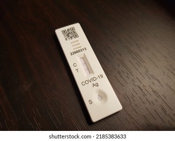 Poznan, Poland - July 23, 2022: Positive Covid-19 Test. Antigene Covid Test On Blac Surface. Self Diagnose. Coronavirus. 