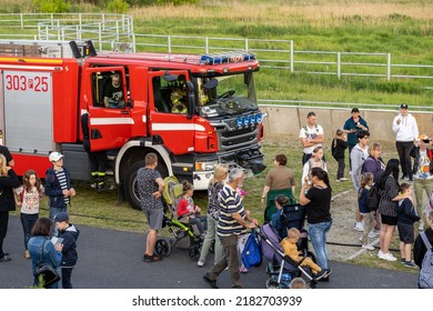 POZNAN, POLAND - Jun 03, 2022: A group of people around a fire truck during an exposition in the new zoo in Poznan, Poland