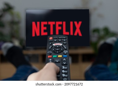 Poznan Poland - June 21.2021: TV Television Netflix logo on screen with remote control in home.