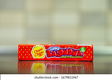 POZNAN, POLAND - Mar 07, 2020: Polish Chupa Chups Chewing Gums With Strawberry Flavor On A Wooden Surface.