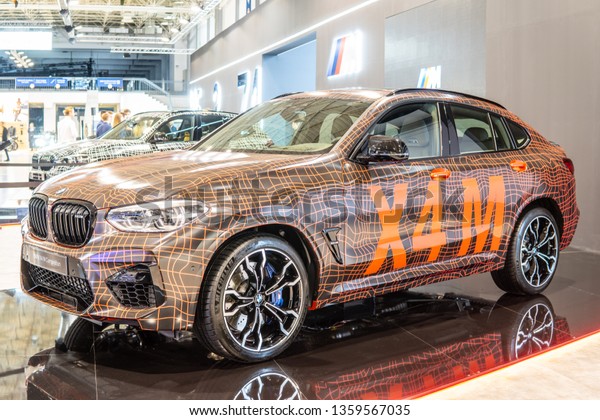 Poznan, Poland, March 28, 2019: BMW X4 M Competition\
with camouflage at Poznan International Motor Show, Second\
generation, G02, compact luxury crossover SUV manufactured by\
German automaker BMW