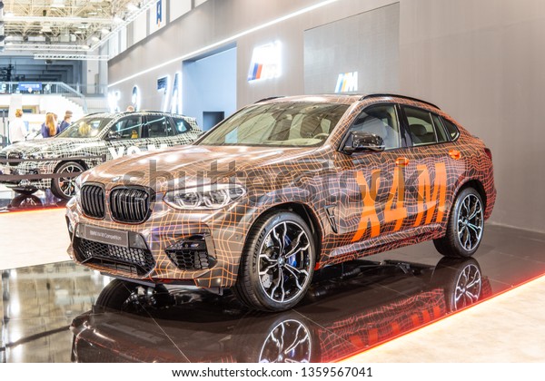 Poznan, Poland, March 28, 2019: BMW X4 M Competition\
with camouflage at Poznan International Motor Show, Second\
generation, G02, compact luxury crossover SUV manufactured by\
German automaker BMW