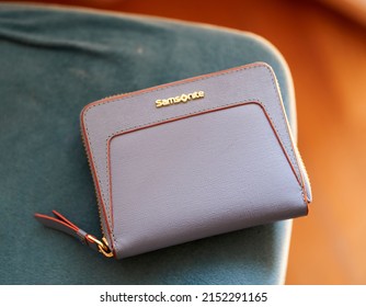 POZNAN, POLAND - May 03, 2022: A Closeup Shot Of A Samsonite Brand Blue Purse For Women On A Table