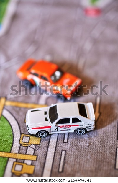 POZNAN, POLAND - May\
05, 2022: A vertical shot of Mattel Hot Wheels toy model car\
collection on a play\
road