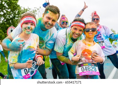 Poznan, Poland - May 20, 2017: Happy Family Participating In The Color Run. The Color Run Is A Worldwide Hosted 5K Fun Race