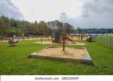 POZNAN, POLAND - Sep 03, 2017: Playground with variation of equipments including sandpit, slide and swing set by the Rusalka lake