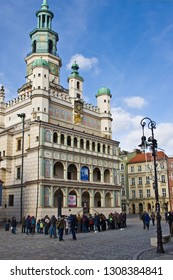 Poznan/Poland - February 6th 2019: Crowd Of Tourists Admiring Old Town Square, Taking Photos Of The Little Goats (koziolki) High Up The Cathedral Building