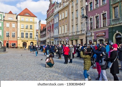 Poznan/Poland - February 6th 2019: Crowd Of Tourists Admiring Old Town Square, Taking Photos Of The Little Goats (koziolki) High Up The Cathedral Building