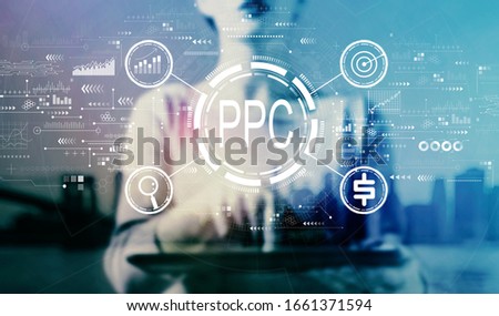 PPC - Pay per click concept with businesswoman using a tablet on a city background