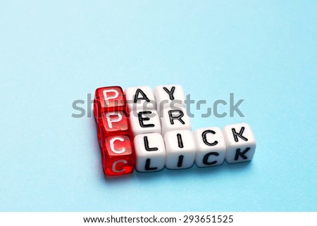 PPC Pay Per Click text on  dices on blue background