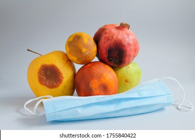 Ppe Virus Spread. Lots Of Fruits That Have Gone Bad. Food Mold. Fridge Fungus. Apple, Pomegranate, Orange And A Lemon Spoiled Storage. Nitrate Poisoning. Food Waste. Public Health Face Mask Safety