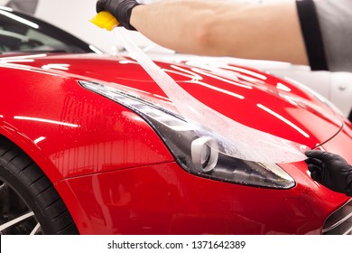 PPF Installation On A Red Sport Car. PPF Is A Short Name For Paint Protection Film. 