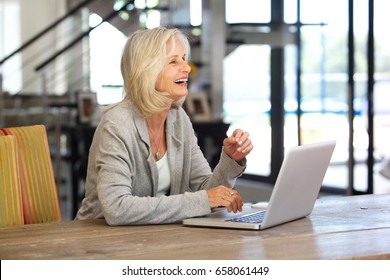 P{portrait Of Happy Older Business Woman Working On Laptop