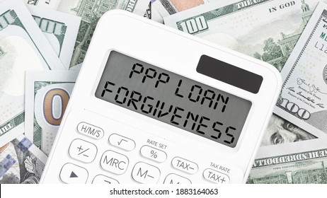 PPP LOAN FORGIVENESS Text On Hundred Dollar Notes. Money With Calculator. Small Business Paycheck Protection Program. Banking And Finance Concept