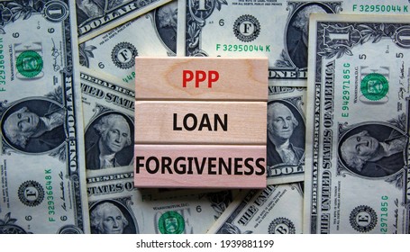 PPP, paycheck protection program loan forgiveness. Concept words PPP loan forgiveness on blocks on background from dollar bills. Business, PPP - paycheck protection program loan forgiveness concept. - Shutterstock ID 1939881199