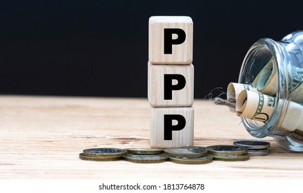 PPP (Paycheck Protection Program) - On Cubes On The Background Of A Capacity With Money. Business And Finance.