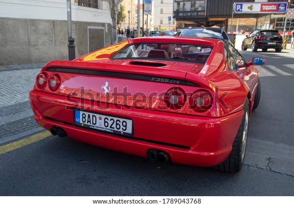 PRAAG , TSJECHIE -   22 JULY 2020: Red parked\
Ferrari F355 gts convertible in the famous red ferarri color. The\
type designation F355 stands for 3500cc engine capacity and five\
valves per cylinder.