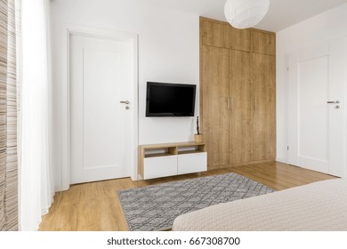 Practical And Minimalist Bedroom TV Wall With Wooden Spacious Wardrobe