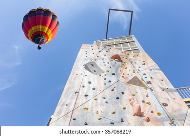 practice climbing wall outdoor and balloon in blue sky 