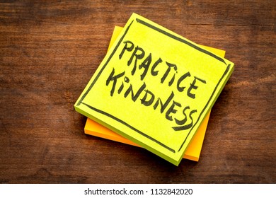 Practice kindness reminder - handwriting on a sticky note against rustic wood - Shutterstock ID 1132842020